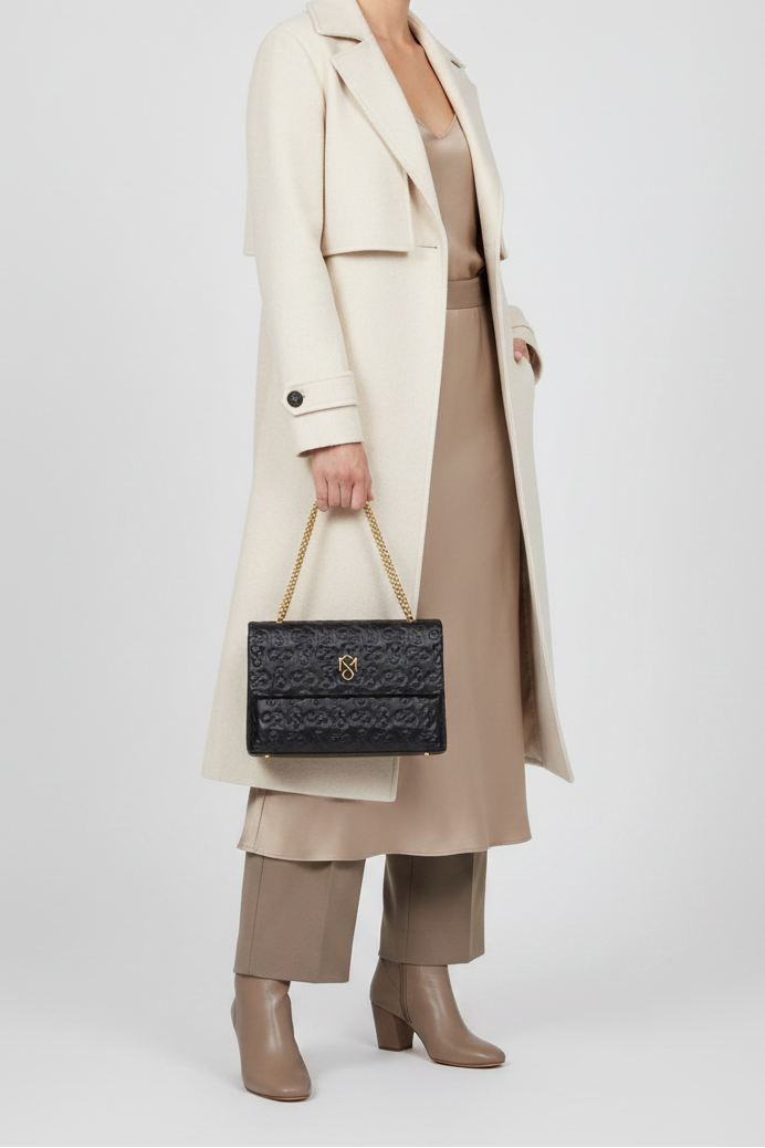 Model holding Signature Luxe Flap Medium – Black/Gold by Shanaè Monèt
